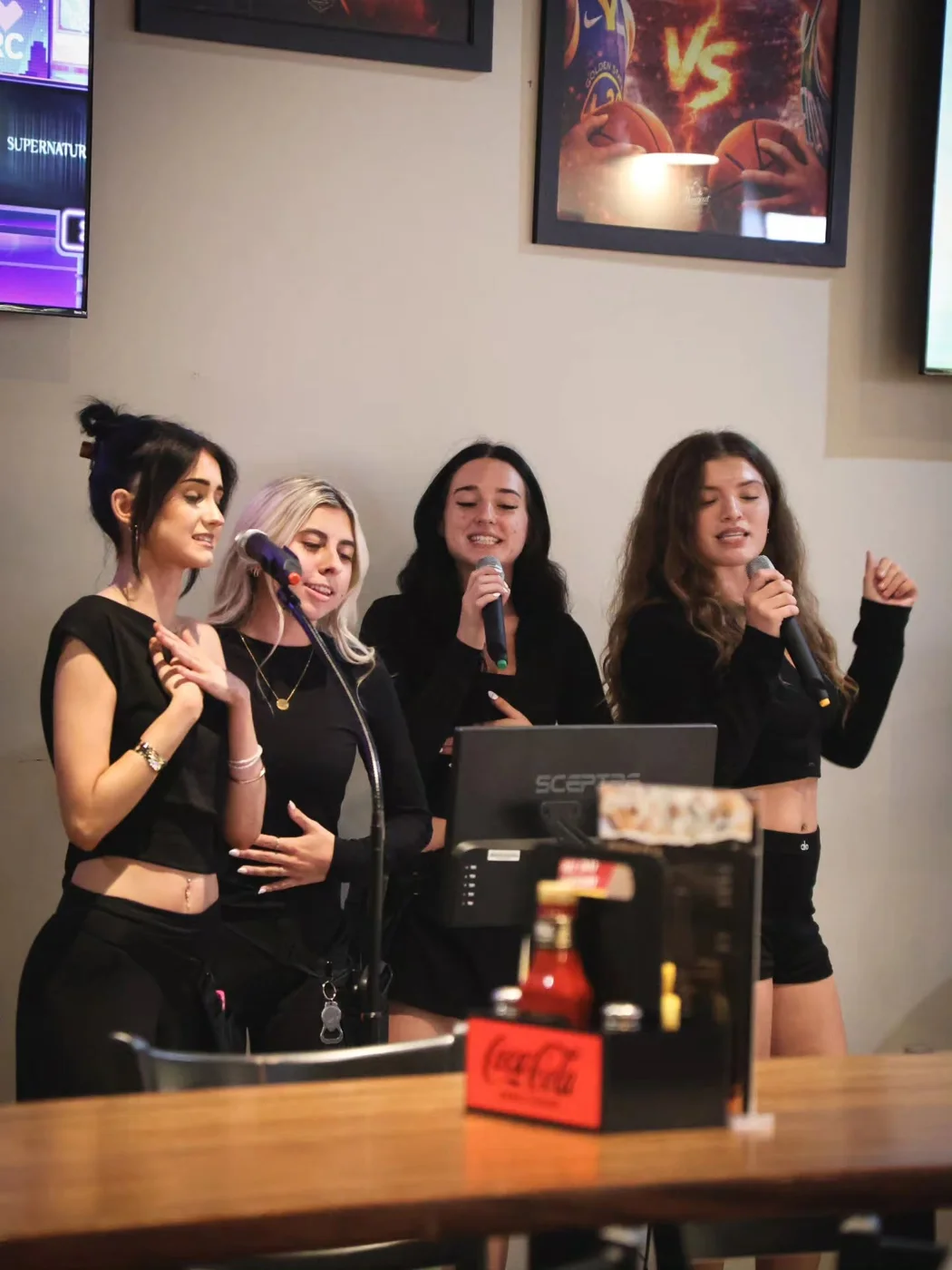 Friends sharing the microphone at The Hangout
